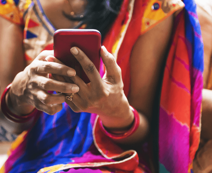 Woman with colorful clothes holding phone