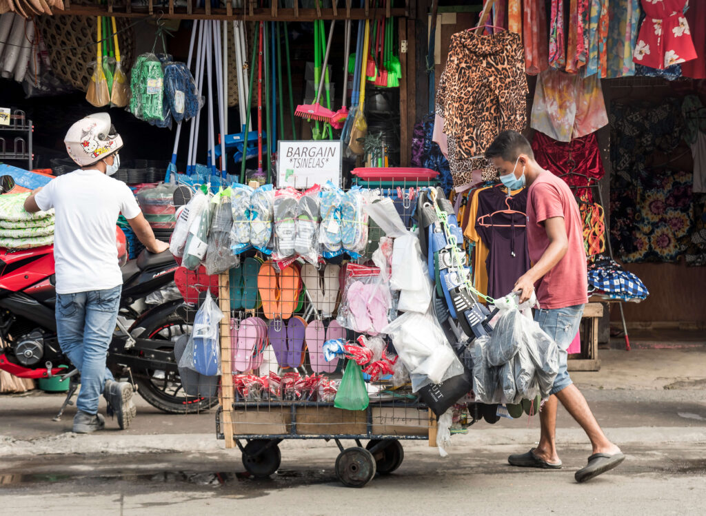 person pushing a cart with goods for sale on it