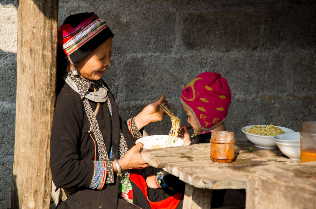 woman and child eating together