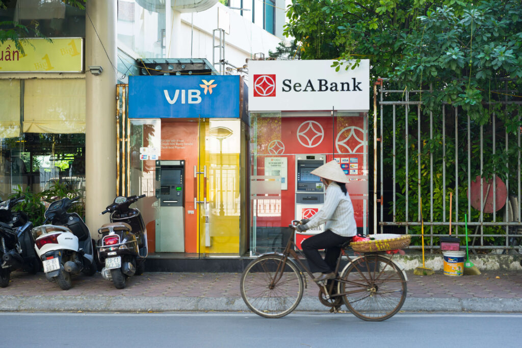 person on bike in front of ATM machines