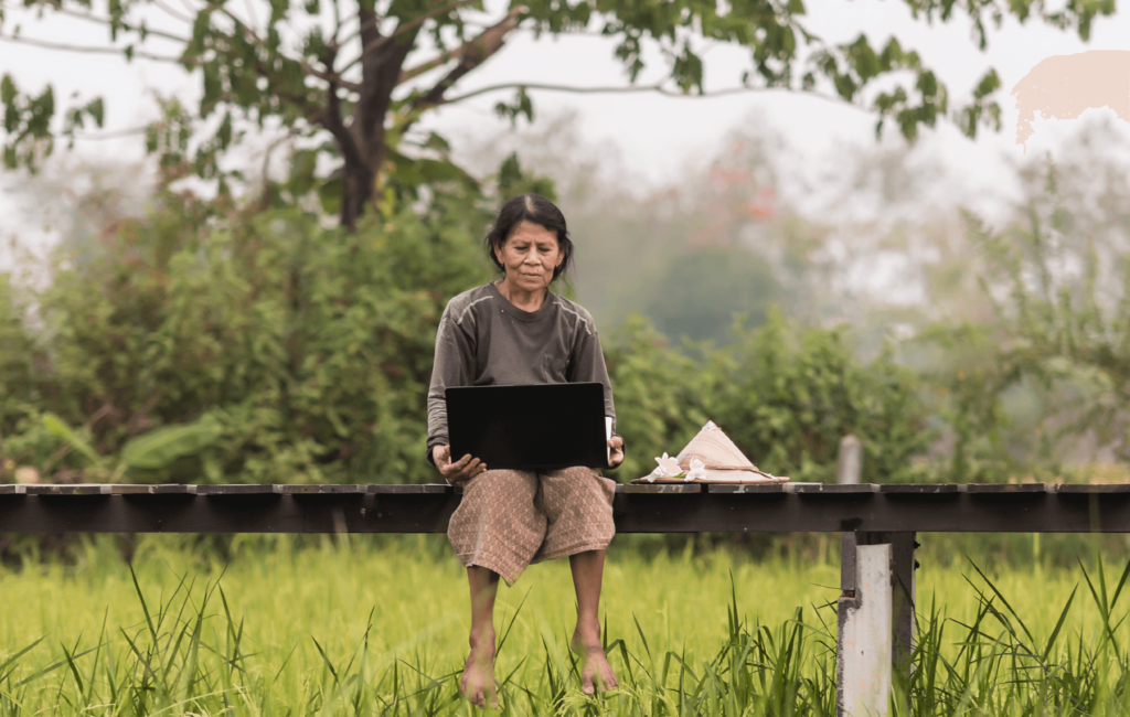 woman using a computer in a field