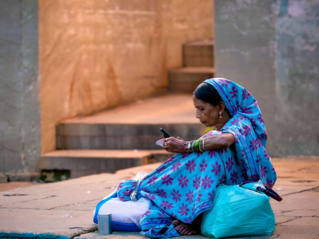 Woman sitting on ground looking at phone