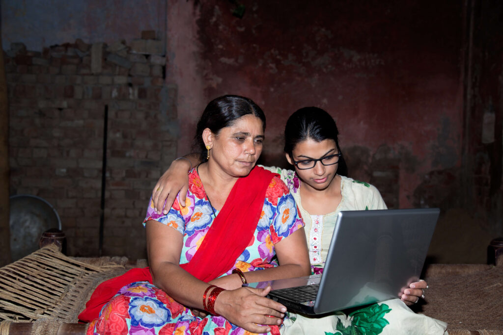 Two women looking at a laptop