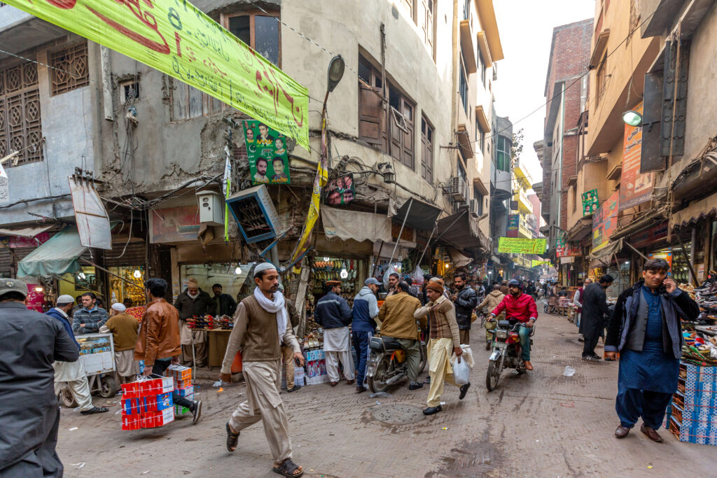 People on a busy street with shopping vendors