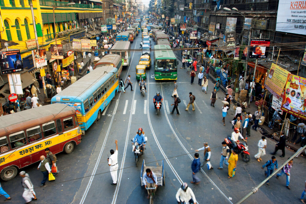 People and cars along a busy street